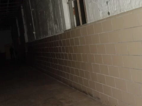 Moundsville Shadow Man stands at the end of a hallway