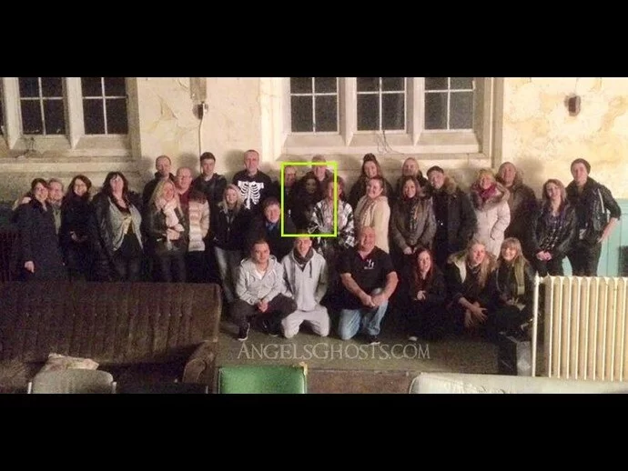 A ghost photobombs an unsuspecting group at Newsham Hospital...