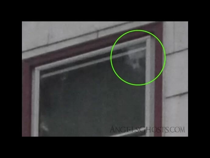 Smiling ghost face peers down from the upstairs window...