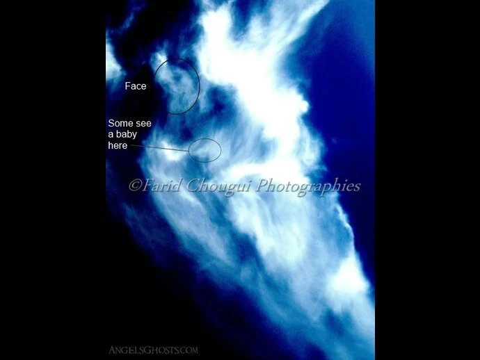 Enhanced angel photo with the head and baby circled.
